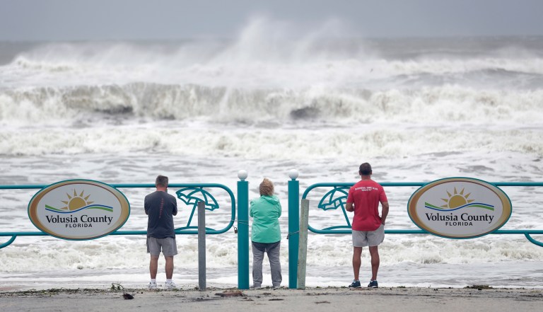 Sightseers watch waves crash on shore as Hurricane Dorian made it's way off the Florida coast Wednesday, Sept. 4, 2019, in Ormond Beach, Fla. 