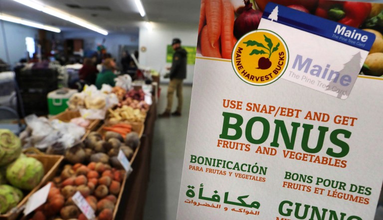 In this Friday, March 17, 2017, file photo, a sign advertises a program that allows food stamp recipients to use their EBT cards to shop at a farmer's market in Topsham, Maine.