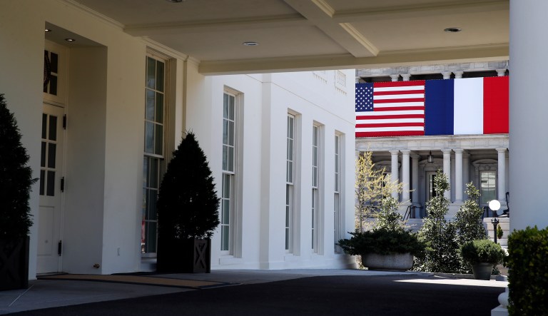 The U.S., and French flags are displayed on the Eisenhower Executive Office Building as seen through the portico of the West Wing of the White House, Friday, April 20, 2018, in Washington. President Donald Trump plans to celebrate nearly 250 years of U.S.-French relations by hosting President Emmanuel Macron at a glitzy White House state dinner on Tuesday. Itâs the first state visit and the first big soiree of the Trump era in Washington.
