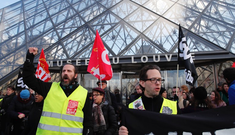 Striking employees demonstrate outside the Louvre museum Friday, Jan. 17, 2020 in Paris. Paris' Louvre museum was closed Friday as dozens of protesters blocked the entrance to denounce the French government's plans to overhaul the pension system.