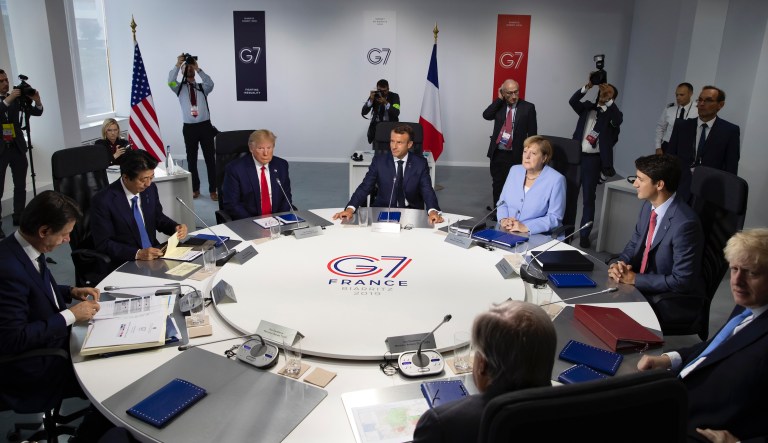 From the left, Italian Prime Minister, Giuseppe Conte, Japanese Prime Minister Shinzo Abe, U.S President Donald Trump, French President Emmanuel Macron, German Chancellor Angela Merkel, Canadian Prime Minister Justin Trudeau, Britain's Prime Minister Boris Johnson attend a work session during the G7 summit at Casino in Biarritz, southwestern France, Monday Aug.26 2019. 