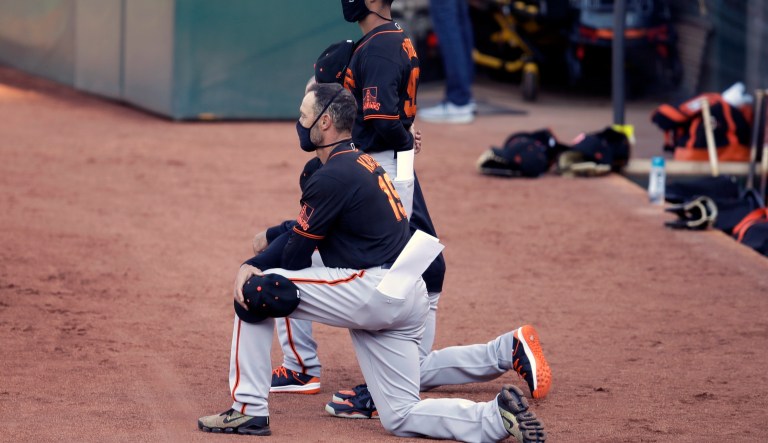 San Francisco Giants manager and some players kneel for national anthem