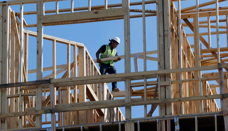 In this Friday, Oct. 6, 2017, photo, workers build an apartment and retail complex in Nashville, Tenn. On Friday, Jan. 26, 2018, the Commerce Department issues the first estimate of how the U.S. economy performed in the October-December quarter.