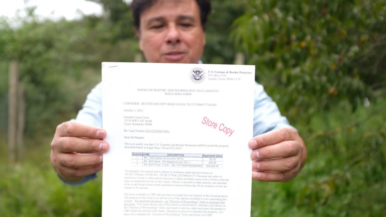 Gerardo Serrano holds up the notice that his car has been seized.