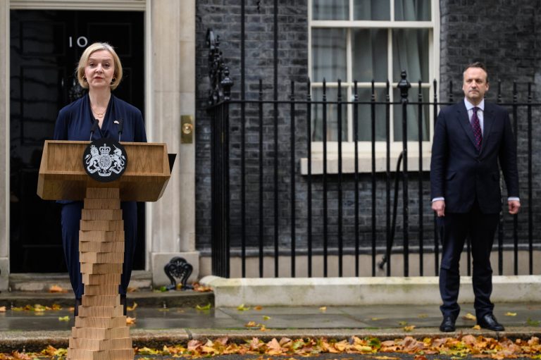 Prime Minister Liz Truss announces her resignation, watches by her husband Hugh O'Leary, as she addresses the media outside number 10 at Downing Street on October 20 in London, England. 