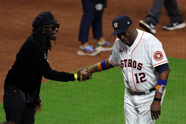 Manager Dusty Baker Jr. #12 of the Houston Astros greets musician Eric Burton following the National Anthem prior to Game One of the 2022 World Series at Minute Maid Park on October 28, 2022 in Houston, Texas.