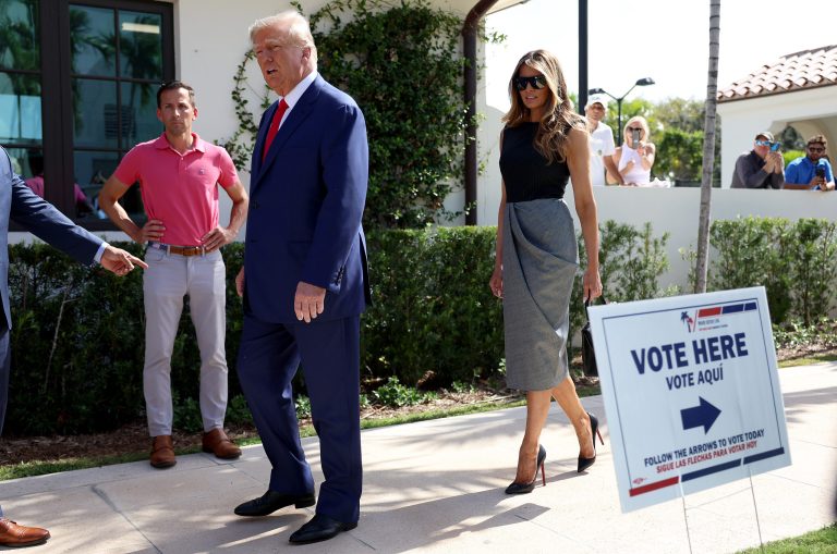 Former President Donald Trump and first lady Melania Trump walk together after voting at a polling station setup in the Morton and Barbara Mandel Recreation Center on November 08 in Palm Beach, Florida. 