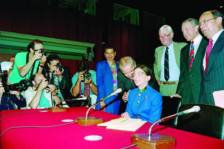 US Senator Joseph Biden (L), chairman of the Senate Judiciary Committee, whispers on July 20, 1993 to judge Ruth Bader Ginsburg shortly before his committee began Ginsburg's confirmation hearing for the position of associate justice of the US Supreme Court. (Photo by Jennifer LAW / AFP)       