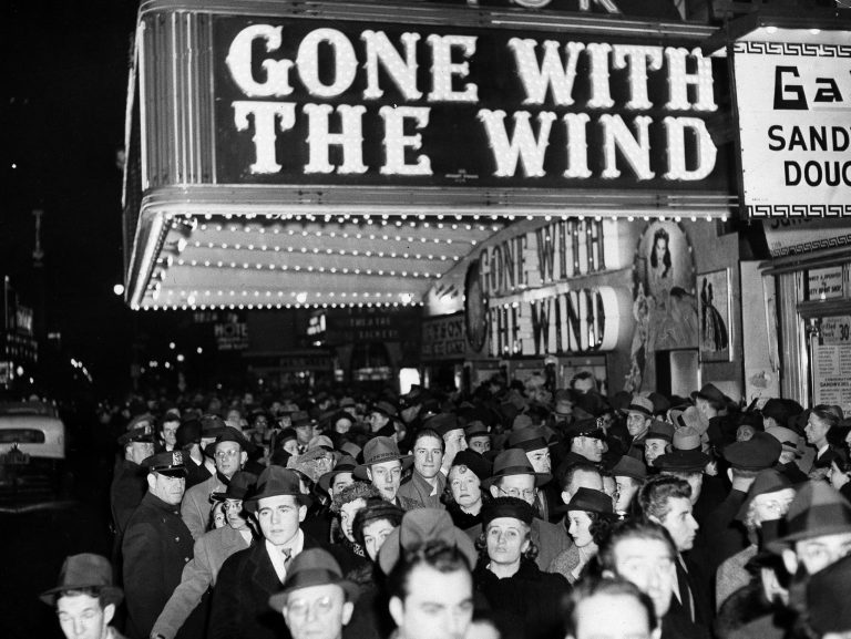 FILE - In this Dec. 19, 1939 file photo, a crowd walks past the Astor Theater during the Broadway premiere of "Gone With the Wind" in New York.  (AP Photo, File)