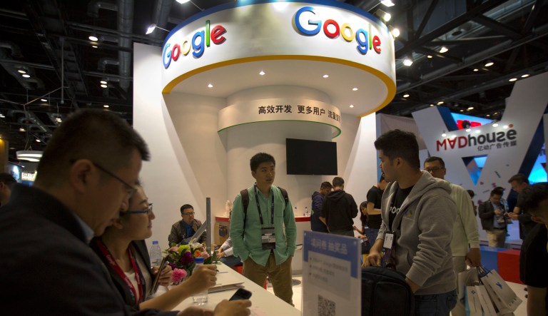 Visitors look at a display booth for Google at the Global Mobile Internet Conference (GMIC) in Beijing, Thursday, April 27, 2017.