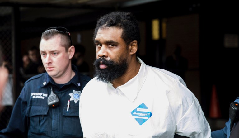 Ramapo police officers escort Grafton Thomas from Ramapo Town Hall to a police vehicle, Sunday, Dec. 29, 2019, in Ramapo, N.Y. Thomas is accused of stabbing multiple people as they gathered to celebrate Hanukkah at a rabbi's home in the Orthodox Jewish community north of New York City.