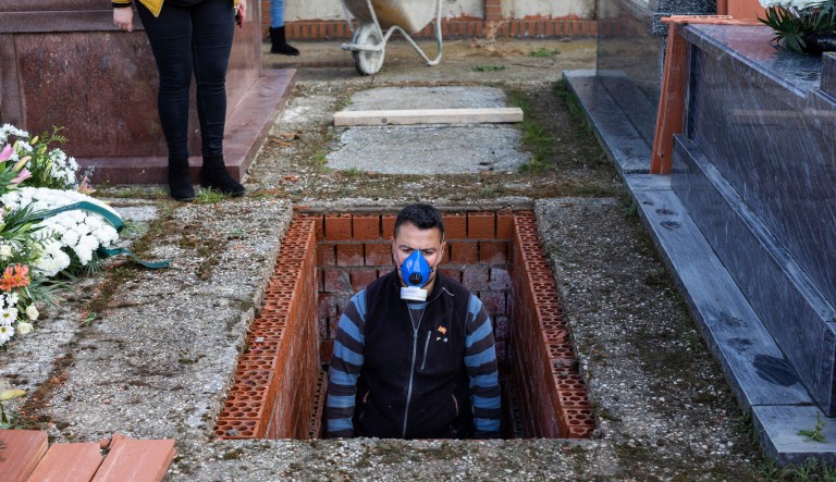 An undertaker prepares a grave during the burial of Rosalia Mascaraque, 86, during the coronavirus outbreak in Zarza de Tajo, central Spain, Wednesday, April 1, 2020. Intensive care units are particularly crucial in a pandemic in which tens of thousands of patients descend into acute respiratory distress. The new coronavirus causes mild or moderate symptoms for most people, but for some, especially older adults and people with existing health problems, it can cause more severe illness or death.