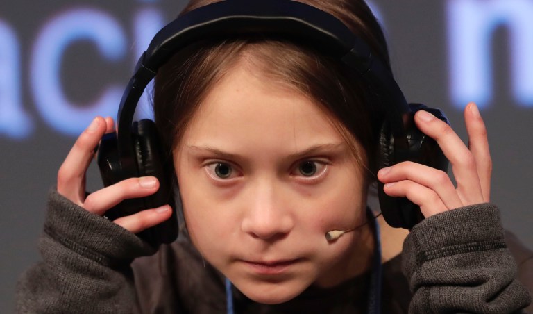 Climate activist Greta Thunberg adjusts the headphones during a press conference in Madrid, Friday Dec. 6, 2019. Thunberg arrived in Madrid Friday to join thousands of other young people in a march to demand world leaders take real action against climate change. 