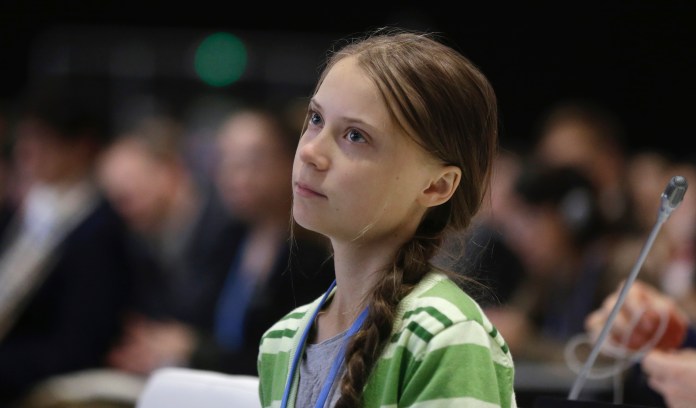 Swedish climate activist Greta Thunberg listens to speeches before addressing a plenary of U.N. climate conference at the COP25 summit in Madrid, Spain, Wednesday, Dec. 11, 2019.     
