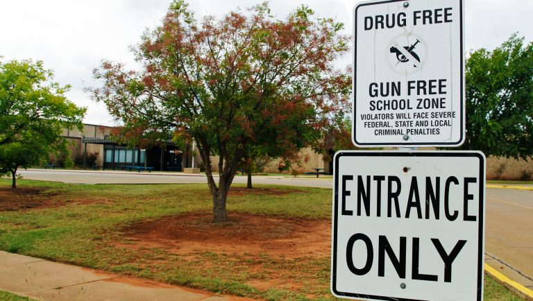 A sign declaring Stillwater Junior High School as a drug free and gun free zone is pictured outside the school in Stillwater, Okla., Wednesday, Sept. 26, 2012.  A 13-year-old student shot and killed himself in a hallway at the schooll before classes began Wednesday, police said, terrifying teenagers who feared a gunman was on the loose. 