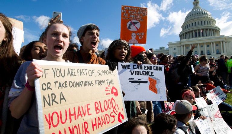 Students hold up their signs during a rally asking for gun control outside of the U.S. Capitol building, in Wednesday, March 14, 2018, in Washington. One month after a mass shooting in Florida, students and advocates across the country participate in walkouts and protests to call on Congress for action.