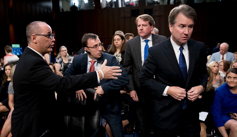 White House counsel Don McGahn, second from right, watches as Fred Guttenberg, the father of Jamie Guttenberg who was killed in the Stoneman Douglas High School shooting in Parkland, Fla., left, attempts to shake hands with President Donald Trump's Supreme Court nominee, Brett Kavanaugh, a federal appeals court judge, right, as he leaves for a lunch break while appearing before the Senate Judiciary Committee on Capitol Hill in Washington, Tuesday, Sept. 4, 2018, to begin his confirmation to replace retired Justice Anthony Kennedy. Kavanaugh did not shake his hand.