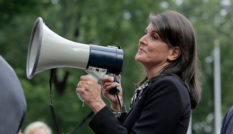 Surrounded by security, United States Ambassador to the United Nations Nikki Haley speaks briefly to people at a protest against Venezuelan President Nicolas Maduro outside United Nations headquarters in New York, Thursday, Sept. 27, 2018.
