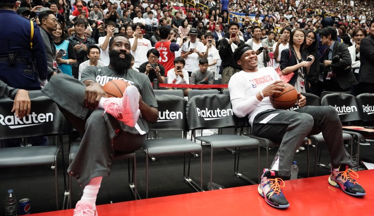 Houston Rockets' James Harden, left, and Russell Westbrook share a light moment during warmups for the team's NBA preseason basketball game against the Toronto Raptors Thursday, Oct. 10, 2019, in Saitama, near Tokyo. 