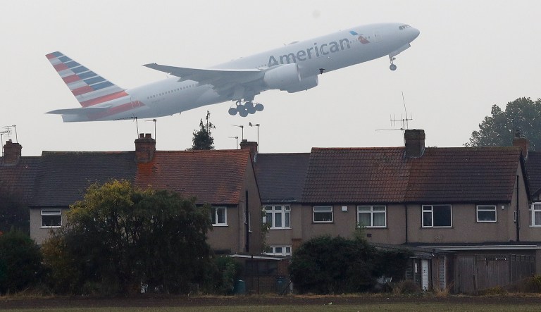 An airplane takes off over the rooftops of nearby houses at Heathrow Airport in Harmondsworth, London, Tuesday, Oct. 25, 2016.