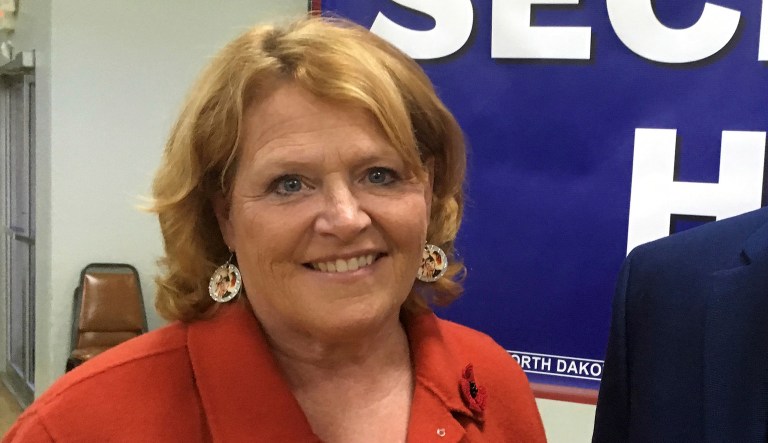 North Dakota Democratic Sen. Heidi Heitkamp and former Republican senator and Defense Secretary Chuck Hagel pose for a photo on Tuesday, Oct. 23, 2018 in Bismarck, North Dakota. Hagel is campaigning across the state for Heitkamp, who is viewed as one of the most vulnerable candidates among red-state Democrats in the Senate. 