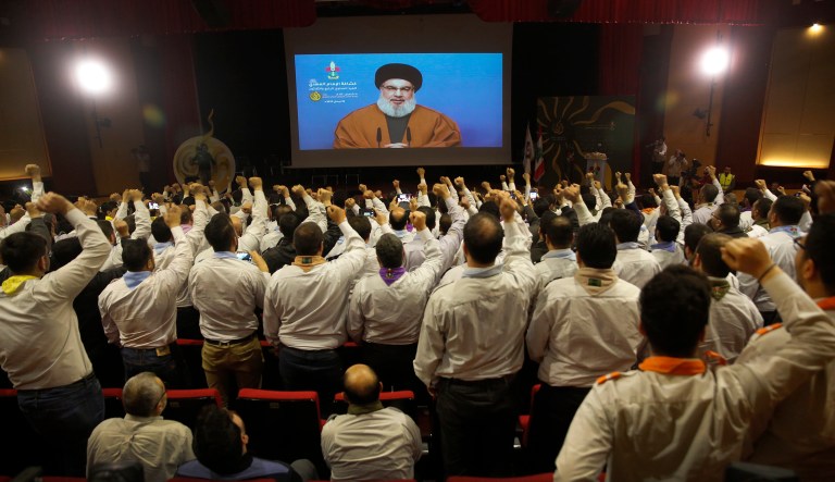 Hezbollah scouts raise their fists and cheer as they listen to a speech by Hezbollah leader Sayyed Hassan Nasrallah, via a video link, during an annual anniversary rally for Hezbollah al-Mahdi scouts, in southern Beirut, Lebanon, Monday, April 22, 2019.