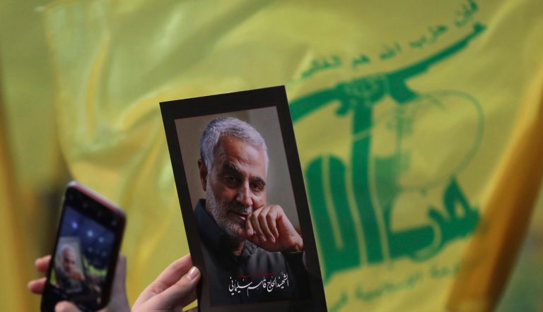 A Hezbollah supporter uses her mobile phone to takes a picture of slain Iranian Revolutionary Guard Gen. Qassem Soleimani during a ceremony marking the anniversary of the assassination of Hezbollah leaders, Abbas al-Moussawi, Ragheb Harb and Imad Mughniyeh and the end of a 40-day Muslim mourning period for slain Iranian Revolutionary Guard Gen. Qassem Soleimani, in the southern suburb of Beirut, Lebanon, Sunday, Feb. 16, 2020. Nasrallah said U.S. President Donald Trump declared war on the Middle East when the U.S. assassinated Soleimani and when the White House announced its plan to end the Palestinian-Israeli conflict. He called on all to resist U.S. influence and its troops presence. 