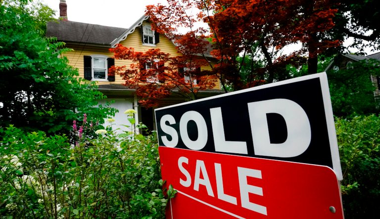 A sale sign stands outside a home in Wyndmoor, Pa., Wednesday, June 22, 2022.