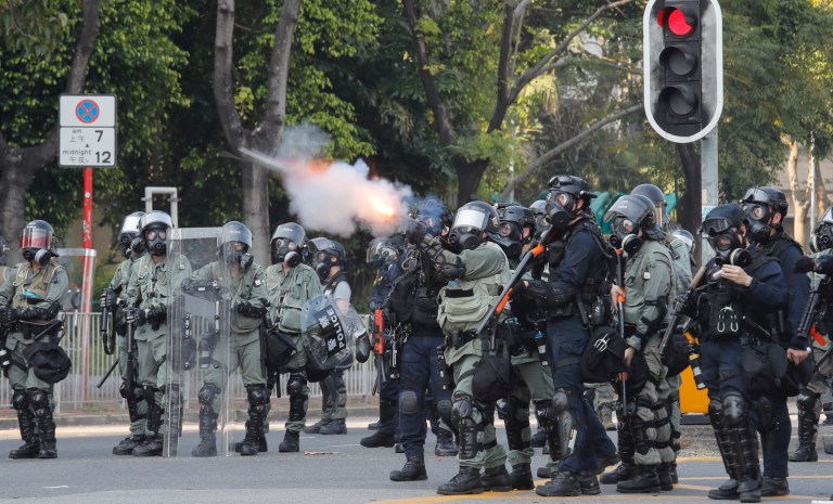 Police fire tear gas at anti-government protesters at Shatin, Hong Kong, Tuesday, Oct. 1, 2019. Thousands of black-clad pro-democracy protesters defied a police ban and marched in central Hong Kong on Tuesday, urging China's Communist Party to "return power to the people" as the party celebrated its 70th year of rule.