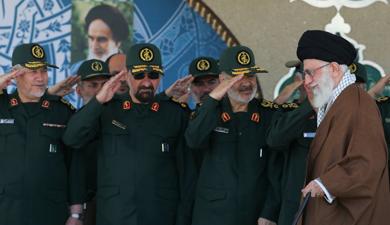 In this picture released by an official website of the office of the Iranian supreme leader on Wednesday, May 20, 2015, Supreme Leader Ayatollah Ali Khamenei, right, arrives at a graduation ceremony of the Revolutionary Guard's officers, while deputy commander of the Revolutionary Guard, Hossein Salami, second right, former commanders of the Revolutionary Guard Mohsen Rezaei, second left, and Yahya Rahim Safavi salute him in Tehran, Iran. Iran's supreme leader vowed Wednesday he will not allow international inspection of Iran's military sites or access to Iranian scientists under any nuclear agreement with world powers.