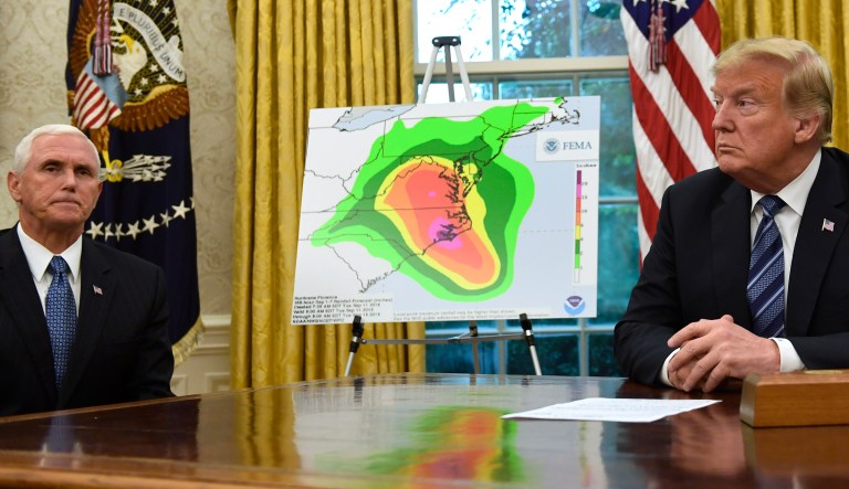 President Donald Trump, right, and Vice President Mike Pence, left, listen during a briefing on Hurricane Florence in the Oval Office of the White House in Washington, Tuesday, Sept. 11, 2018.