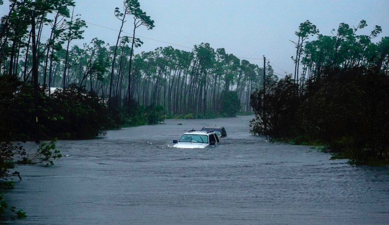 Cars sit submerged in water from Hurricane Dorian in Freeport, Bahamas, Tuesday, Sept. 3, 2019. Dorian is beginning to inch northwestward after being stationary over the Bahamas, where its relentless winds have caused catastrophic damage and flooding.