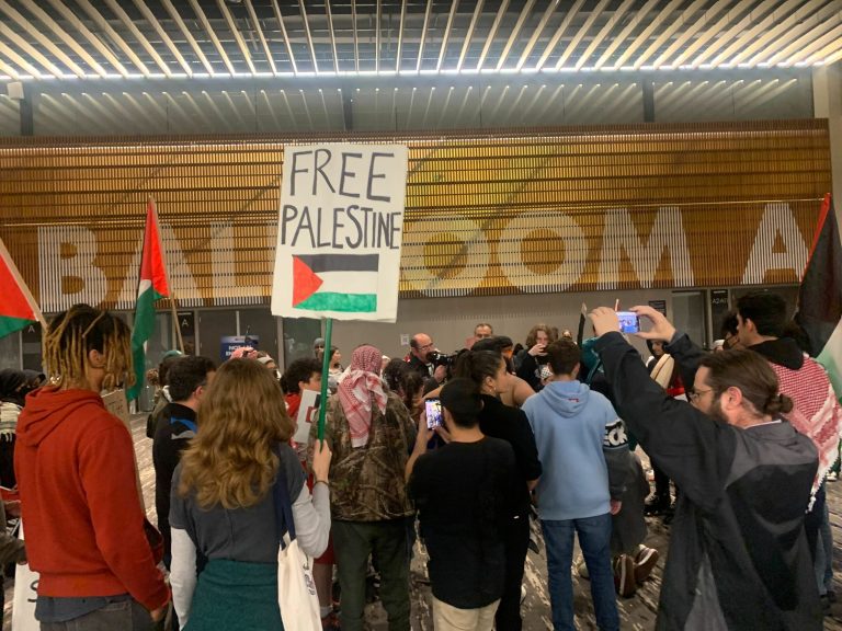 Outside the convention hall, protesters, many of whom have been Democratic campaign staffers or volunteers in previous election cycles, organized a sit-in near one of the doors. They later breached the entry and caused the candidate forum to be cut short.