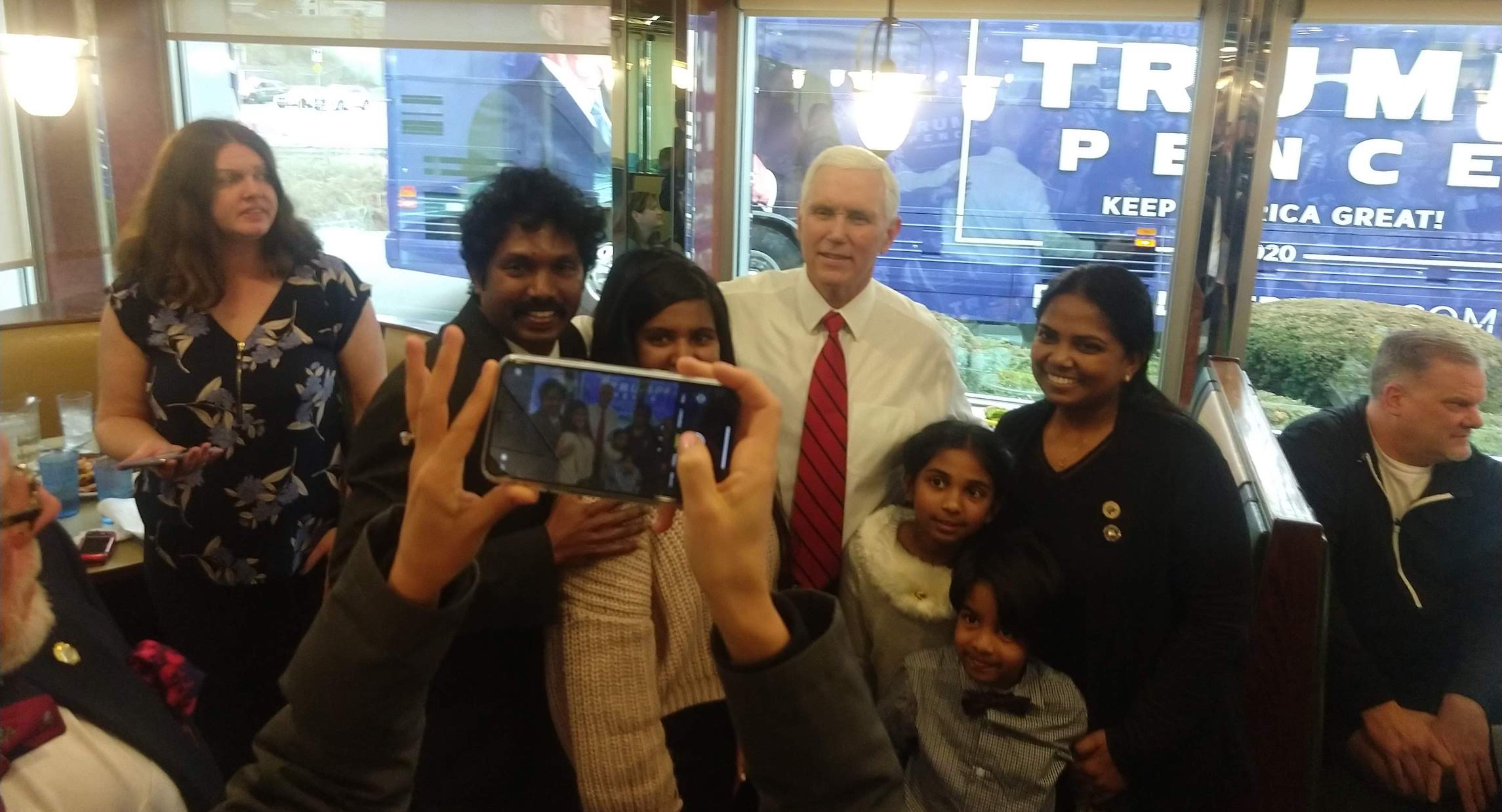 While Trump plays stadiums, Pence tries to woo the heartland one diner at a time