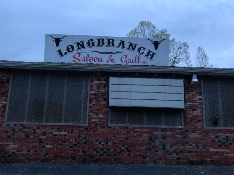 Michelle Ennis behind the counter at Dickerson Market, a general store, holding a bucket of their amazing fried chicken.