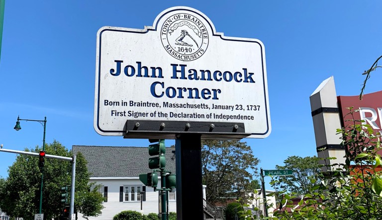 A sign indicating John Hancock Corner is seen in Braintree, Massachusetts.
