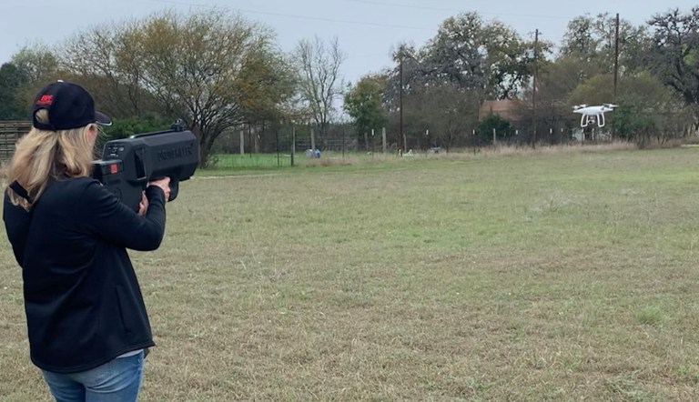 An attendee at the Border Security Expo's demonstration day tries out IXI's DroneKiller.