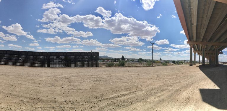 The bollard-style fence ends abruptly in downtown El Paso.