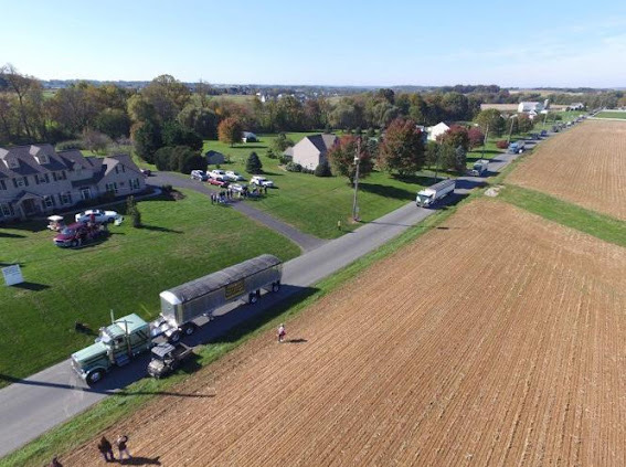A long line of trucks drive past the entrance of Hostetter Grain Inc. in an act of solidarity for Barry Hostetter, who is batting pancreatic cancer.