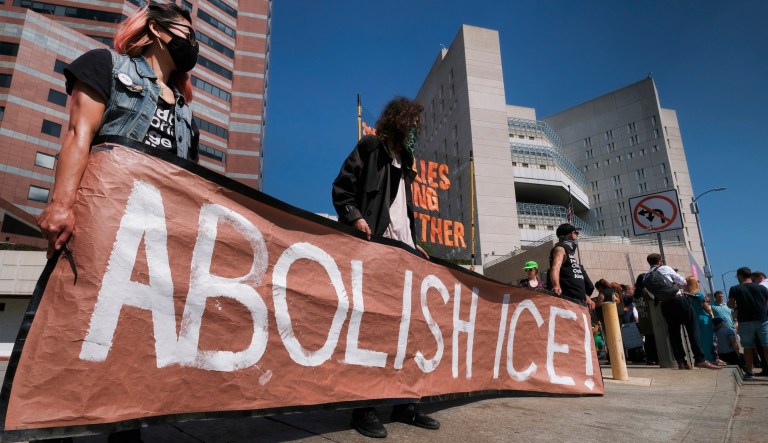 Protesters display a sign that reads "Abolish ICE" during a rally in front of the Immigration and Customs Enforcement facility in downtown Los Angeles on July 2, 2018.