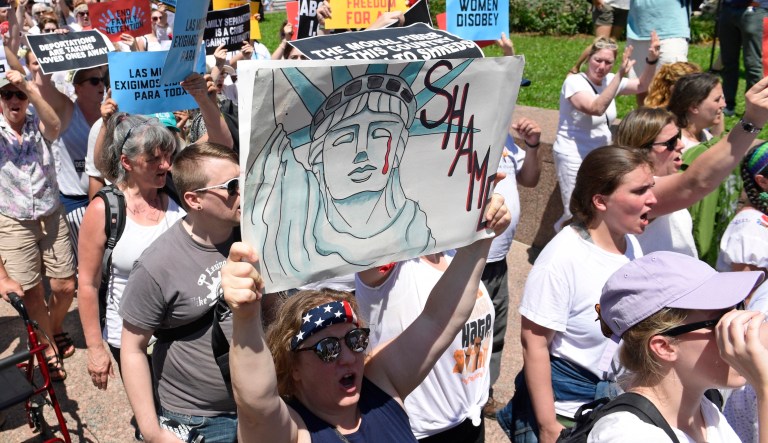 Protesters march during a rally on immigration in Washington on June 28, 2018.