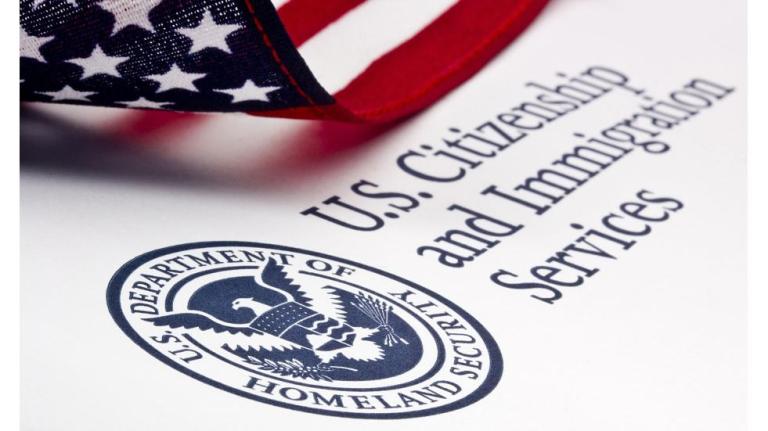 A Mexican immigration agent escorts Central American migrants back to Mexico after they applied for asylum in the U.S., as they walk across International Bridge 1 Las Americas, which connects Laredo, Texas in the U.S. with Nuevo Laredo, Mexico, Thursday, July 18, 2019.