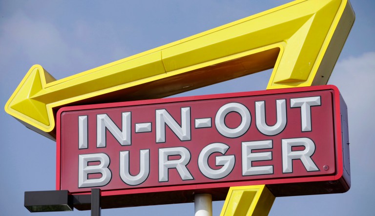 Signage outside at the In-N-Out Burger restaurant in Costa Mesa, California, U.S., on on Wednesday, February 6, 2013.