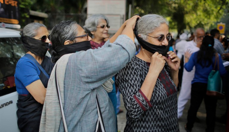 Indian Dalit women, members of the outcast community once known as untouchables, listen to a speaker at a sit in protest on Human Rights Day near the Indian Parliament in New Delhi, India, Tuesday, Dec. 10, 2013. The Dalits were demanding rights to land, livelihood and equal growth opportunities. 