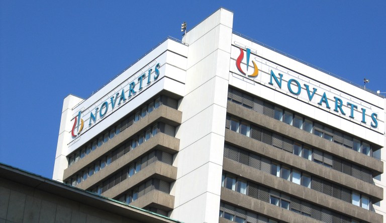 A sign for the pharmaceutical company Novartis is shown on an office building.