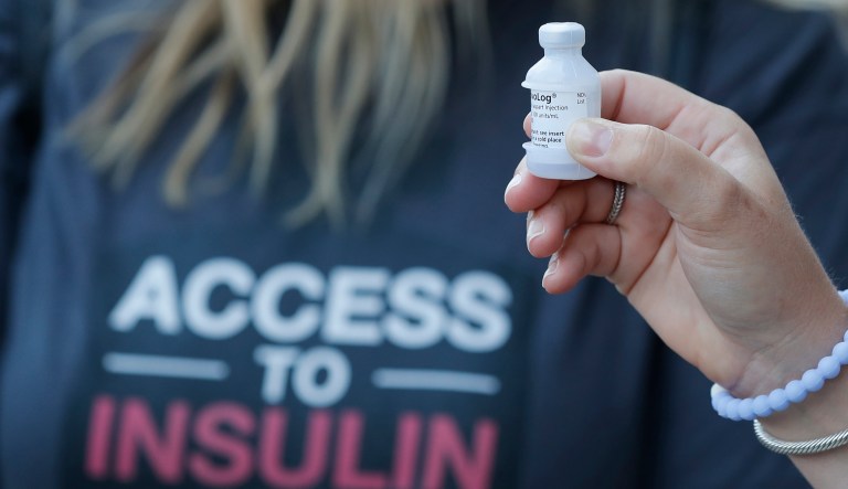 A patient holds a vial of insulin during a news conference outside the Olde Walkersville Pharmacy, Sunday, July 28, 2019, in Windsor, Ont.