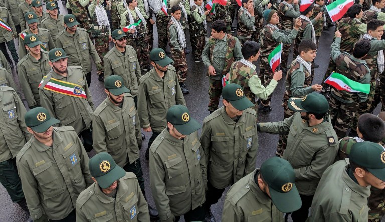 School students wave their national flags as Revolutionary Guard members arrive in Azadi, freedom square, during a ceremony celebrating the 40th anniversary of Islamic Revolution, in Tehran, Iran, Monday, Feb. 11, 2019.