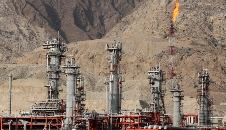 FILE - In this Jan. 22, 2014 file photo, a gas flare burns at a gas refinery in the South Pars gas field, on the northern coast of the Persian Gulf, in Asalouyeh, Iran. Iran likely will further embrace Beijing as an alternative market for its crude oil and financial transactions amid uncertainty over the nuclear deal. That doesnât mean China offers a safe haven to Iran without conditions. Analysts say Beijing will try to extract the maximum benefit, and there is growing concern that China may take advantage of Iran.