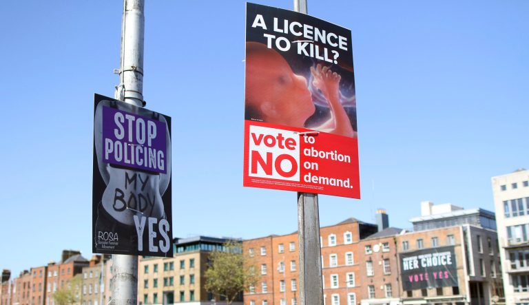 In this photo taken on May 17, 2018, pro and anti-abortion poster's on lampposts, in Dublin, Ireland. In homes and pubs, on leaflets and lampposts, debate rages in Ireland over whether to lift the country's decades-old ban on abortion. Pro-repeal banners declare: "Her choice: vote yes." Anti-abortion placards warn against a "license to kill." Online, the argument is just as charged _ and more shadowy _ as unregulated ads of uncertain origin battle to sway voters ahead of Friday's referendum, which could give Irish women the right to end their pregnancies for the first time. The emotive campaign took a twist this month when Facebook and Google look last-minute decisions to restrict or remove ads relating to the abortion vote. It is the latest response to global concern about social media's role in influencing political campaigns for the U.S. presidency and Brexit. (AP Photo/Peter Morrison)