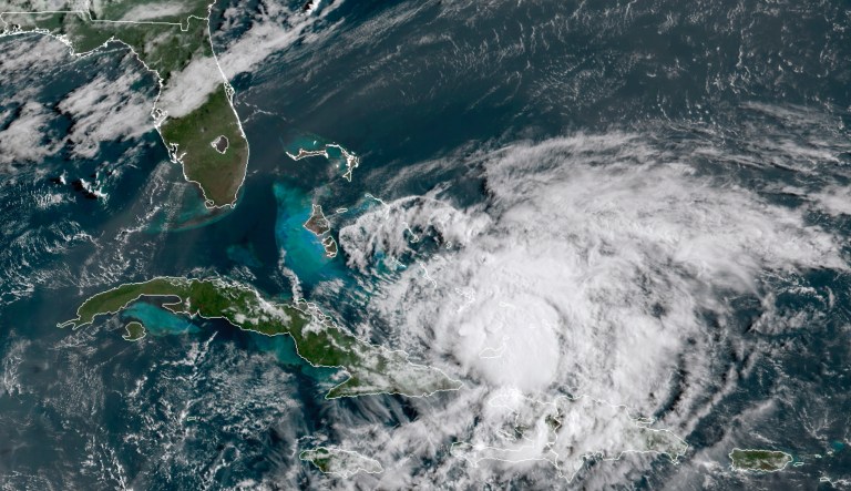 In this GOES-16 satellite image taken Friday, July 31, 2020, at 8:40 a.m. EDT., and provided by NOAA, Hurricane Isaias churns in the Caribbean. Hurricane Isaias kept on a path early Friday toward the U.S. East Coast as it approached the Bahamas, parts of which are still recovering from the devastation of last year's Hurricane Dorian.